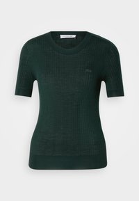 Tamnozelena rebrasta pletena majica kratkih rukava s okruglim izrezom i Lacoste logotipom na prsima. Prilagođen kroj s teksturiranim materijalom.