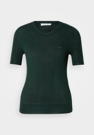 Dunkelgrüner, gerippter Strickpullover mit kurzen Ärmeln, Rundhalsausschnitt und Lacoste-Logo auf der Brust. Figurbetontes Design mit strukturiertem Stoff.