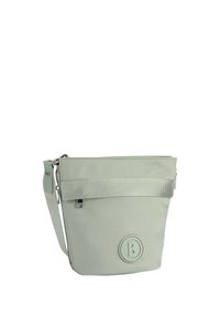 Borsa a secchiello in nylon morbido di colore verde chiaro, con zip superiore, tracolla regolabile e un'accortezza di tessuto testurizzato. Dettaglio del logo circolare sul fronte.