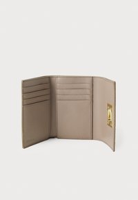 Beige leather wallet with a smooth texture. Features multiple card slots, a gold-tone hardware clasp, and a minimalist design.