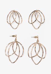 Gold-tone earrings featuring layered, open designs. Includes a pair of studs and a pair of dangling earrings with a floral-inspired shape.