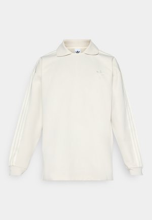 Long-sleeve, cream-colored polo shirt with a collar, featuring three vertical stripes on the sleeves and a subtle logo on the chest.