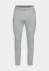 Grå sweatpants med en struktureret stof, elastisk talje og tætsiddende form. Har hvide sidestriber og et lille logo på låret.