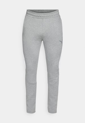 Grijze sweatpants van een gestructureerde stof, met een elastische tailleband en een getailleerde pasvorm. Heeft witte zijpanelen en een klein logo op de dij.