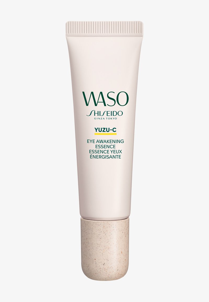 Tube med WASO Shiseido Yuzu-C Eye Awakening Essence med en beige hætte mod en ensfarvet hvid baggrund.