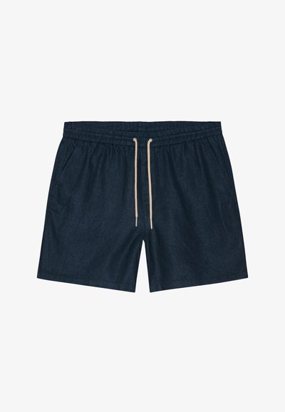 Tummansiniset uimaportsarit, joissa on joustava vyötärö, säädettävä nyöri ja kaksi sivutaskua. Kankaan pinta näyttää sileältä hienovaraisella kuviolla.