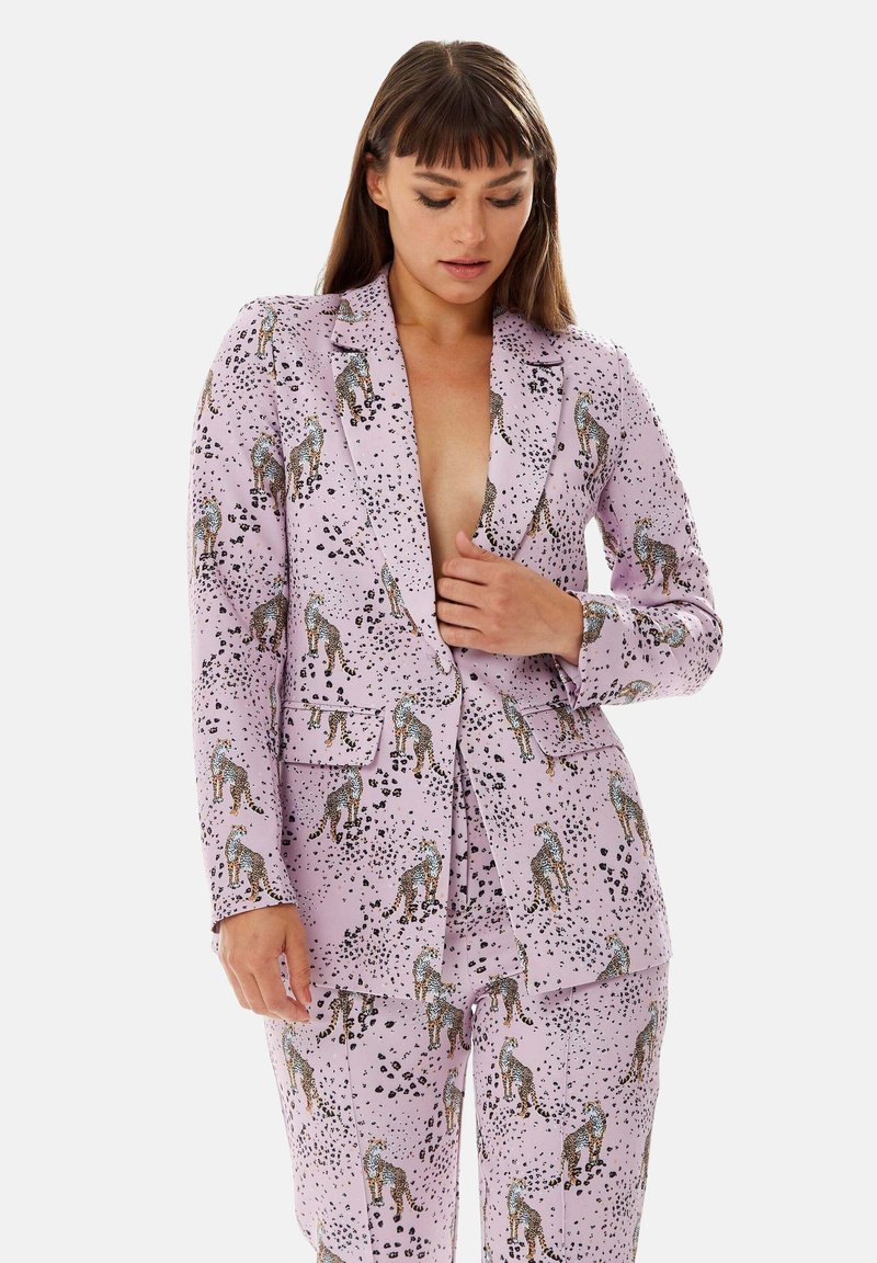 Purple blazer and pants set featuring a leopard print pattern with black and blue accents. Material is smooth with a tailored fit.