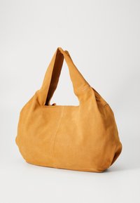Suede bag in mustard yellow with a slouchy design, featuring a single shoulder strap and minimal stitching detail. Soft texture and rounded shape.