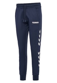Pantalon de jogging bleu marine avec taille élastique, cordon, poches latérales, logo Hummel blanc sur la cuisse et motif chevrons sur la jambe droite.