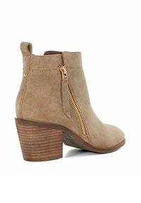 Tan suede ankle boot with a rounded toe, back loop, and a gold zipper on the side. Features a textured, stacked wooden heel.