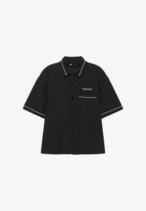 Black short-sleeve button-up shirt with white piping on collar and sleeves, front pocket with "WATER SIGNS" text and star accents.