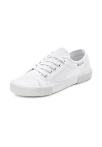 White canvas sneakers with a low-top design, lace-up closure, and rubber sole featuring ribbed texture. Side logo detail present.