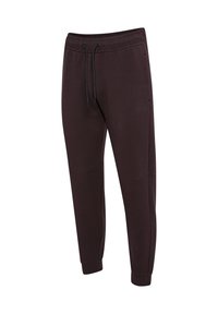 Mörkbruna joggingsbyxor i mjukt material, med en elastisk midja och dragsko, smalnande ben och sidofickor.