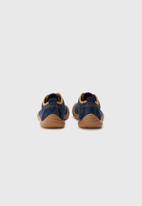 Blue suede shoes with a rounded design, rubber soles, and tan accents at the heel and collar. Stitching detail visible on the sides.