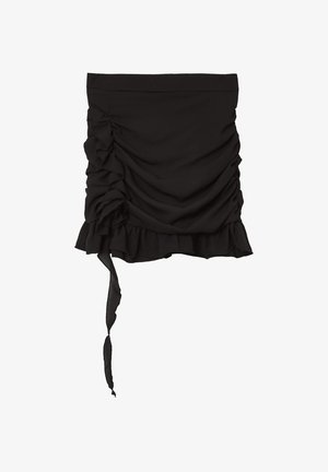 Black mini skirt with gathered fabric and ruffle detailing. Features a tie accent on one side and a textured, smooth finish.