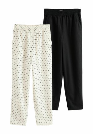 Two pairs of elastic waist pants, one solid black and one white with black polka dots, shown flat against a white background.