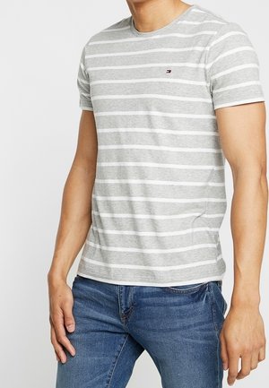 Gray and white striped short-sleeve t-shirt, round neckline, soft fabric, small logo on the chest, paired with blue jeans.