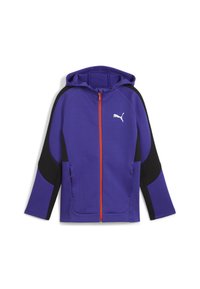 Lillasest zip-up kapuuts, millel on mustad aksendid, kapuuts, elastsed mansetid, küljetaskud ja valge logo rinnal.