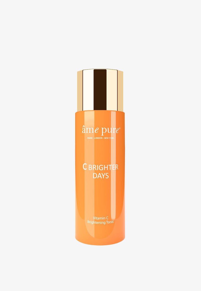 Vitamin C oplysende tonic i en blank orange flaske med et guld låg. Har fet skrift i hvidt, der viser produktnavn og detaljer.