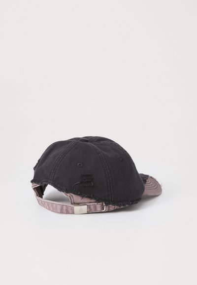 Black denim cap with a distressed design, featuring a faded pink brim and adjustable strap with a metallic buckle.
