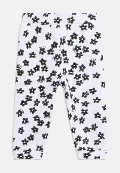 Λευκά παιδικά κολάν με μαύρο μοτίβο σκορπισμένων λουλουδιών και ελαστική ζώνη μέσης, με μικρές λεπτομέρειες κειμένου μέσα σε κάποια λουλούδια.
