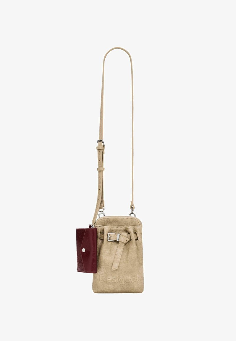 Small beige crossbody bag with buckle detail and attached dark red wallet, adjustable strap, and silver hardware.
