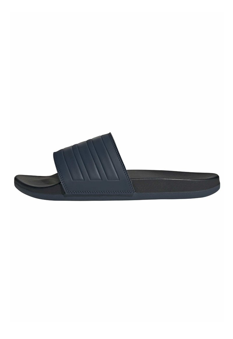 Navy slide sandal made of textured rubber, featuring a wide band with horizontal ridges and a soft, cushioned footbed.