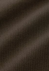 Brown ribbed fabric with a soft texture, featuring vertical lines. The material appears dense and slightly elastic, suitable for various garments.