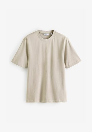 Camiseta de algodón beige con mangas cortas, escote redondo y diseño liso. Presenta una textura suave y un corte recto. Sin patrones ni acentos visibles.