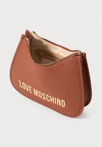 Mala de mão em pele sintética castanha com forma curvada, apresentando um logótipo em tom dourado "LOVE MOSCHINO" e fecho de zíper, com interior beje.