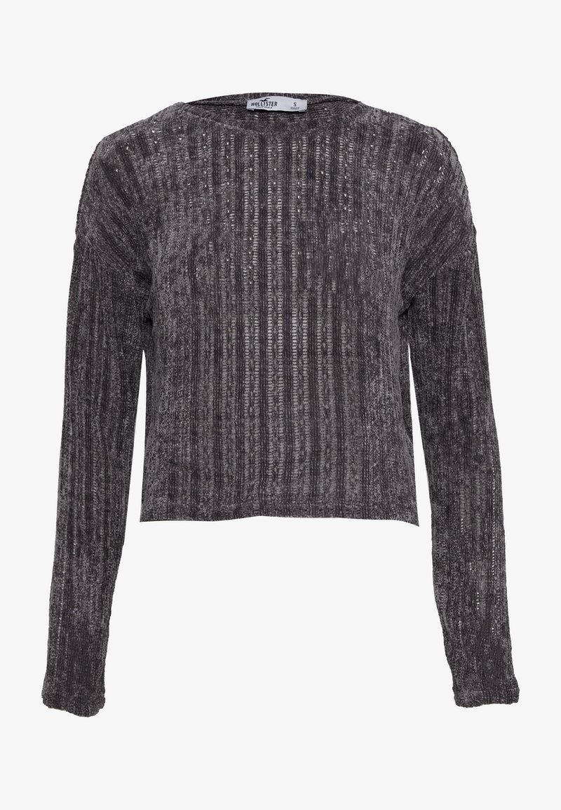 Pull gris foncé court en tissu texturé. Comprend des manches longues et un motif côtelé vertical avec un léger éclat.