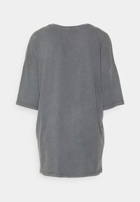 Šedé oversize tričko vyrobené z jemné bavlny, se klasickým kulatým výstřihem a krátkými rukávy. Hladký povrch, minimalistický design a bez grafiky.