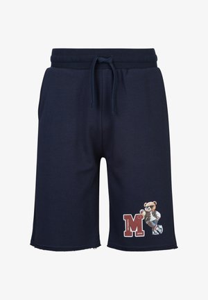 Marineblaue Shorts mit Kordelzug in der Taille und einem Motiv eines Bären mit Sonnenbrille und Collegejacke, der sich auf ein großes rotes "M" am rechten Bein lehnt.