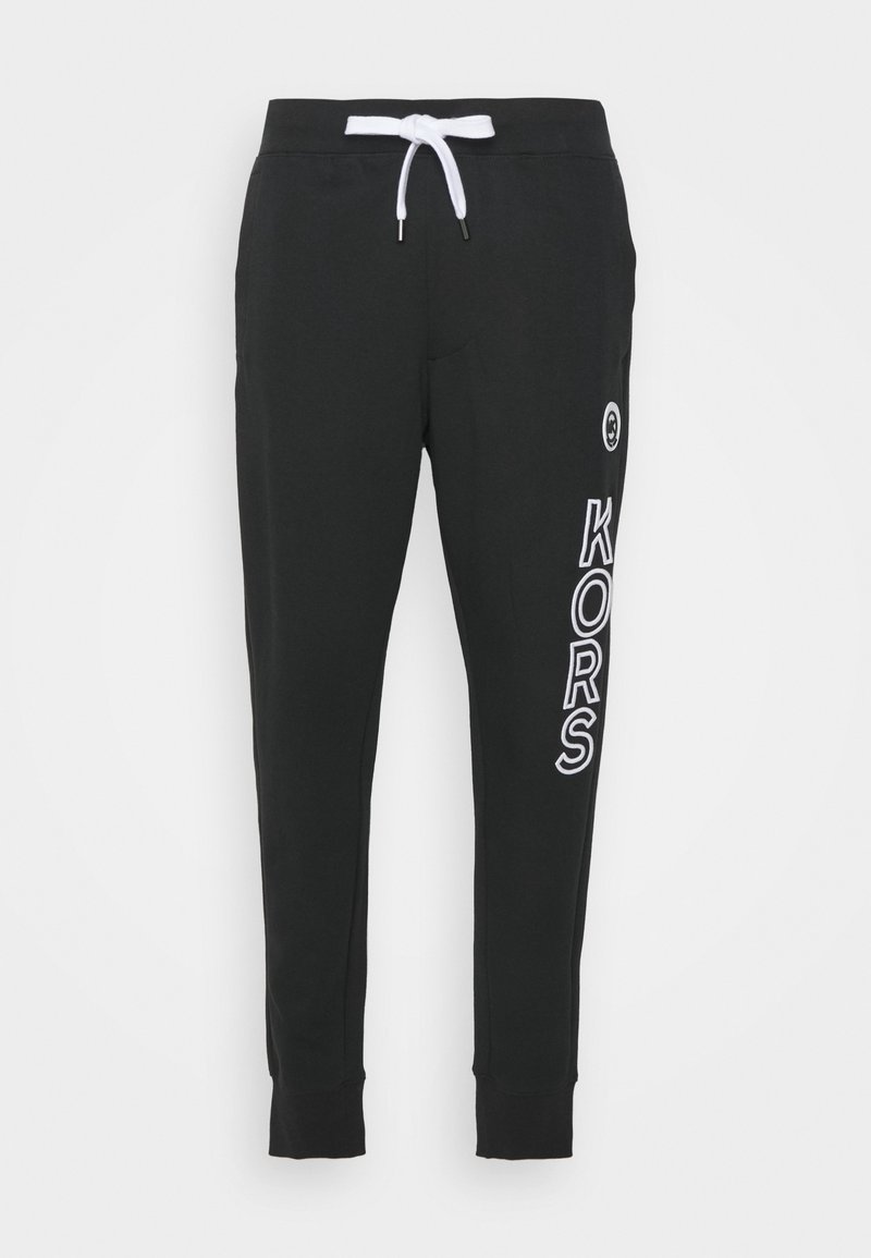 Svarta sweatpants i mjukt tyg, med en vit dragsko, ribbade muddar och "KORS"-logotypen tryckt i vitt längs vänster ben.