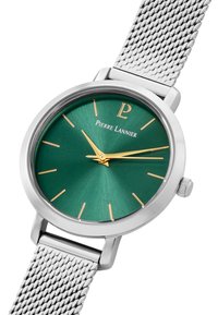 Round watch with a green sunburst dial, gold hands, and markers. Silver stainless steel mesh band, minimalist design, and logo displayed prominently.