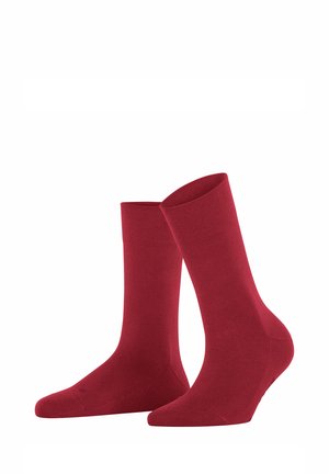 Calze di cotone rosso con una trama liscia, design a metà polpaccio e punta rinforzata, caratterizzate da un colore uniforme senza motivi o accentuazioni visibili.