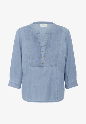 Light blue, denim-like blouse with a round neckline, three-quarter sleeves, front pleating, and five button closure. Soft texture.
