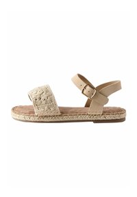 Beige espadrille sandaal met een geprofileerde, decoratieve voorkant, enkelgesp en een zacht suède binnenzool, met gevlochten jute rand.