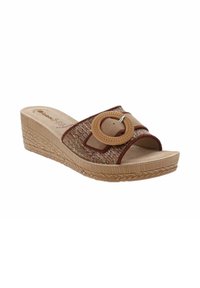 Sandale compensée avec tige en tissu tressé marron, arborant un grand détail de boucle ronde. Semelle en liège avec un motif texturé.