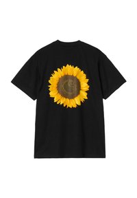 Camiseta de algodón negra con un gran estampado de girasol amarillo en la parte posterior. Cuello redondo y mangas cortas, con un ajuste relajado.