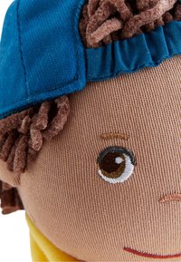 Soft fabric doll with a brown face, blue cap, and short brown textured hair. Features embroidered eyes and a yellow shirt.