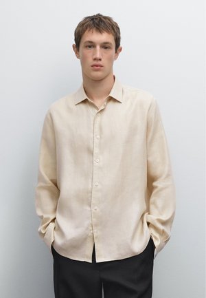 Beige linen button-up shirt with long sleeves, a pointed collar, and a relaxed fit. Featuring five front buttons and a smooth texture.
