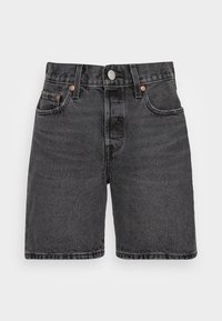 Černé džíny šortky s vysokým pasem, pěti kapsami a měděnými detaily. Tkanina má měkký, texturovaný povrch.