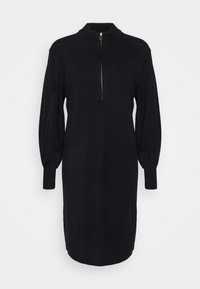 Robe tricotée noire avec un col haut, une fermeture éclair sur le devant, et de longues manches bouffantes. Présente des poignets côtelés et une silhouette droite.