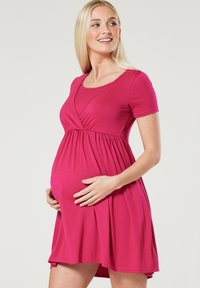 Pink short-sleeve maternity dress with a wrap design, gathered waist, and soft texture, fitted at the bodice and flowing at the skirt.