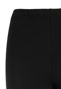 Zwarte legging met een elastische tailleband en een soepele katoenmix stof, met een aansluitende pasvorm en zonder opvallende patronen.