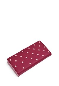 Magenta wallet made of smooth leather, featuring a pattern of white polka dots, slim design with a flap closure and visible stitching.