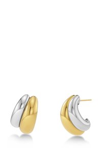 Två hängande örhängen med en blank yta. Det ena är silverfärgat och det andra guld-färgat, med mjuka, böljande former.