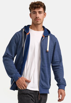 Blue zip-up hoodie with a contrast inner lining, drawstrings, and front pockets. Features textured fabric and orange accents.