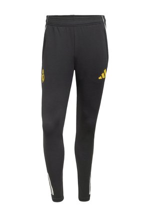 Schwarze Sporthose mit elastischem Bund, mit gelben Logos von Real Madrid und Adidas sowie weißen Streifen an den Seiten.